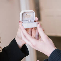 Nebraska Diamond engagement ring in jewel box held by two hands.